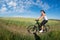 Mountain biking happy sportive girl relax in meadows sunny countryside