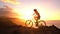 Mountain biking MTB cyclist woman cycling on bike trail at sunset by ocean