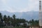 Mountain with blue sky and green plum trees with white clouds