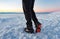 Mountain Boot with crampons on while hiking in the mountains in winter.