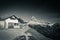 Mountain cabin refuge beside tre cime di lavaredo in dolomites mountain range in sunny snowy winter in black and white
