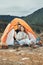 Mountain, camping and couple relax in tent and happy together in winter, nature or environment. Happy, people and rest
