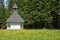 A mountain chapel surrounded by a meadow