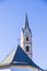 Mountain church with bell tower with pointed roof