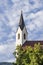 Mountain church with bell tower with pointed roof