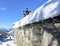 Mountain church Ermita de San Lorenzo after a snowfall with roof covered with snow and icicles. Piornedo, Lugo, Spain.