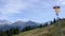 Mountain climber carrying a lot of climbing equipment in the Mischabel mountain range in the Swiss Alps above Saas green valley an