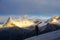 Mountain climber on Nevado Pisco glacier at sunrise with the four peaks of Nevado Huandoy in the background