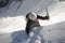 Mountain climber reaches the edge of a summit ridge and exits a steep north face in windy and nasty weather in the Swiss Alps