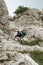 Mountain climber in steep vertical wall climbing the via ferrata in Julian Alps