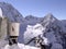 A mountain climber takes a break to cook food in the snow