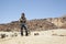 Mountain climber walking on volcano rocks.