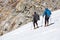 Mountain Climbers Man and Woman walking on steep Ice Slope