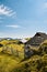 Mountain cottage hut or house on hill Velika Planina alpine meadow landscape. Eco farming. Travel destination for family hiking. K