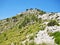 Mountain crest with grass and blue sky