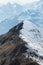 A mountain crest in the italian Alps, half covered with snow