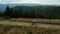 Mountain cycling drone view against stunning spruce forest hills enjoying time