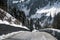 Mountain dangerous curved road in winter mountains. Winter Driving - Winter country road road through a mountains landscape.