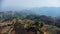 Mountain destroyed by human for cultivate plants. Aerial view of mountains covered in haze from burning forests.