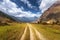 Mountain dirt road at sunset in summer. Himalayan mountains