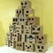 A mountain of emoticons carved from cardboard boxes. Funny, sad, angry and gullible