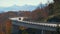 Mountain fall landscape with Linn Cove Viaduct, near Blowing Rock, Blue Ridge Parkway, North Carolina, USA. Driving cars