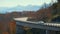 Mountain fall landscape with Linn Cove Viaduct, near Blowing Rock, Blue Ridge Parkway, North Carolina, USA. Driving cars