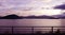 Mountain, footpath fence and sea at sunset