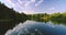 Mountain forest of green trees and calm lake, beautiful panoramic view