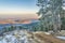 Mountain forest road with pine trees covered by frost