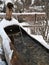 Mountain fountain made from a wooden trunk dug inside covered with snow.