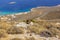 Mountain goat on a rocky landscape overlooking Diakofti port in Kythira island, Greece