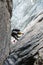 Mountain guide on a hard granite climb to a high alpine peak in the Swiss Alps