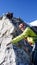 Mountain guide leading male client to the summit of a high alpine peak on a beautiful summer day