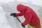 A mountain guide with a shovel check the snow cover for avalanche danger in the mountains, an adrenaline outdoor winter freeride