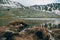 Mountain highlands lake lanscape with snowy hills and water reflection