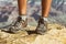 Mountain hike man hiker trekking travel walking with hiking shoes closeup of feet standing