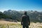 Mountain hiker at high viewpoint looking at the valley