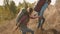 Mountain hiker man and woman climbing a steep hill.