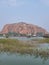 Mountain hillock hills cave lake view plantation fertile ruralscape hindu temple watertank waterbody