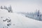 Mountain hills after a huge blizzard. Splendid outdoor scenewith snow covered fir trees, Happy New Year celebration concept.