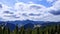 Mountain hilly rural scenery, fluffy clouds. Spruce trees in the foreground. time lapse video