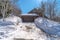 Mountain home in Park City Utah with snowy driveway leading to gray garage door