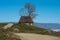 Mountain homestead in the autumn. House with thatched roof