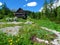 Mountain hut at Triglav lakes valley and Julian alps in Gorenjska, Slovenia with colorful flowers in front