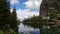 Mountain lake Agnes after rain. Forest, clear water and cloudy sky background.