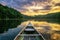 Mountain lake and canoe at sunset