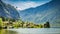 Mountain lake and cottages between by mountains, Austria, Alps