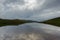 Mountain lake. Dramatic dark clouds. Water surface