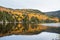 Mountain lake with forested shores during the autumn colour season